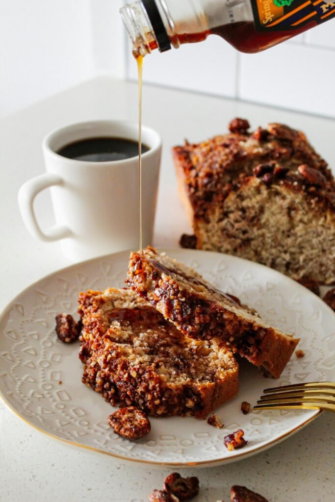 Freshly baked moist banana bread loaf with cup of Coffee
